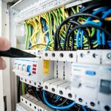 Emergency electrician working on a switchboard in Melbourne