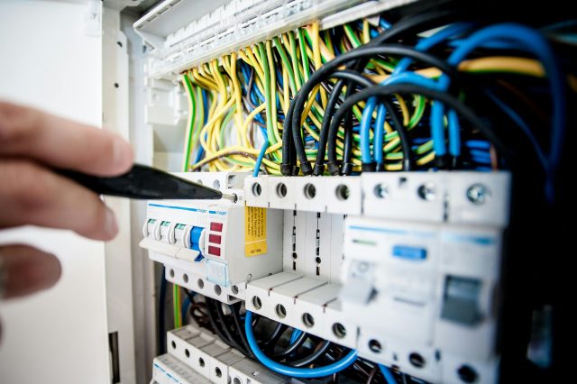 Emergency electrician working on a switchboard in Melbourne 