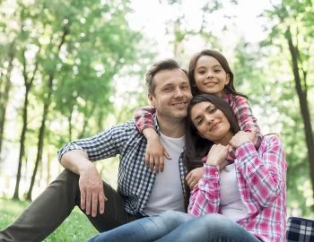 A happy family enjoying time together outdoors, representing the family-oriented services of Migration Solutions. Let our migration agents help you reunite with loved ones in Australia.