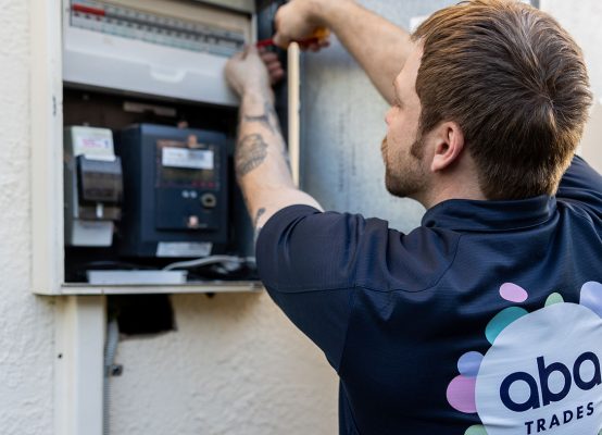 Electrician Adelaide from ABA Electrical working on a switchboard, performing electrical maintenance.