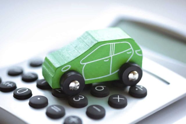 Green car model on a calculator, representing a novated lease calculator at Vehicle Solutions for car leasing and finance options , including salary packaging, tax benefits, and insurance in Australia.