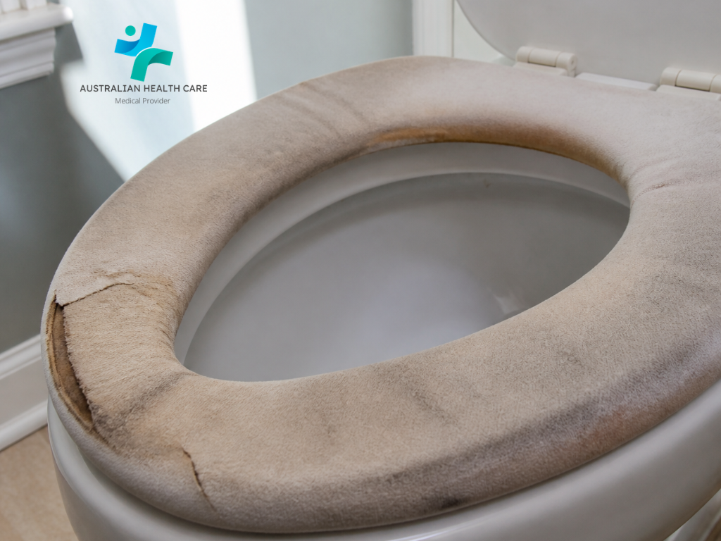 Close-up of a worn soft toilet seat cushion showing flattened padding and a damaged outer covering