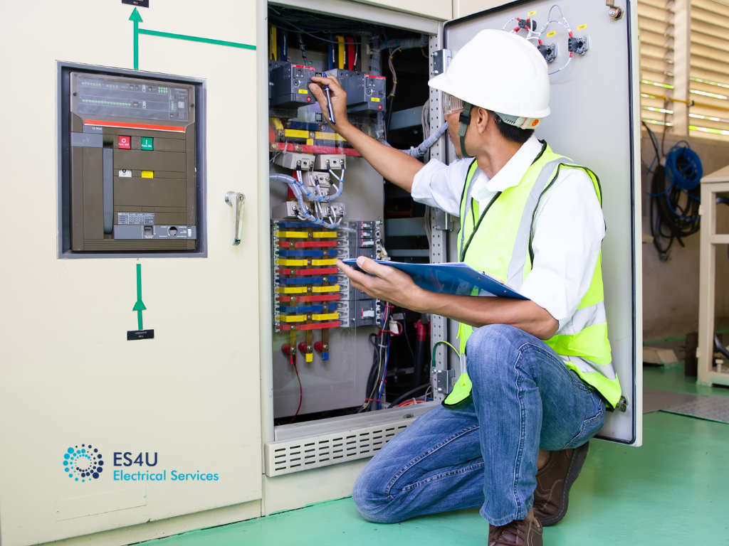Industrial electrician Sydney inspecting an electrical switchboard