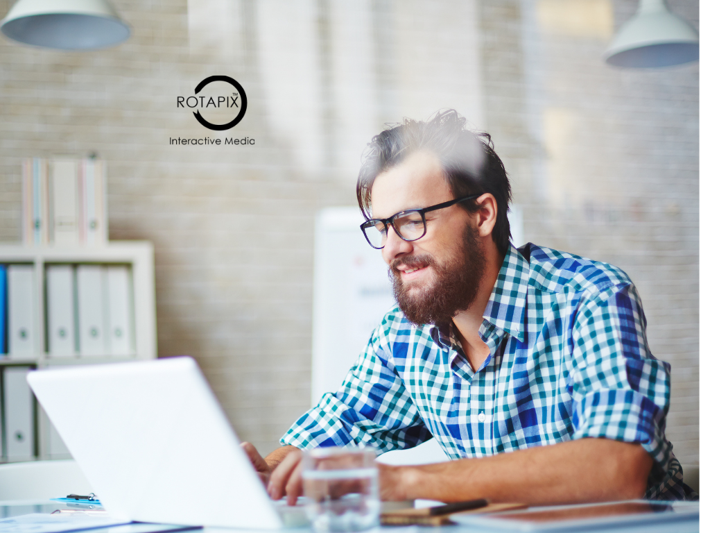 Business manager reviewing an AI readiness audit on a laptop to assess company processes and automation opportunities.