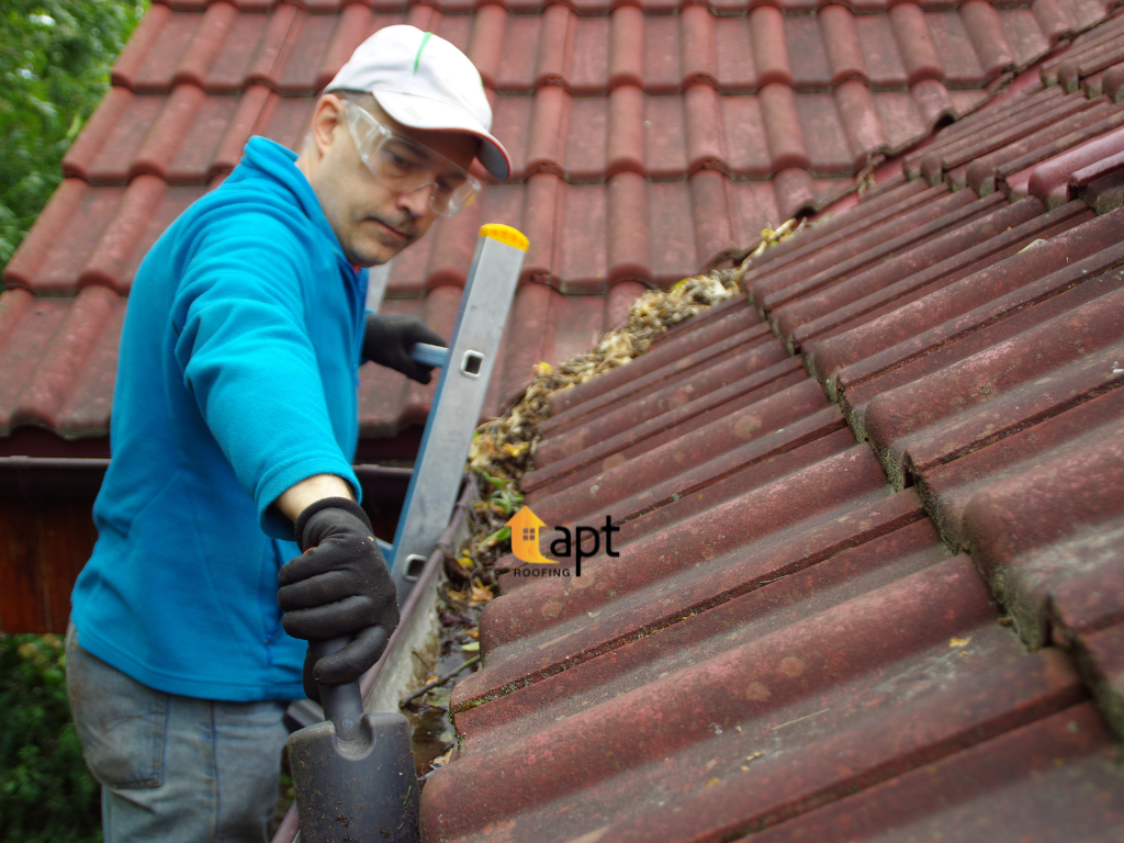 Storm-damaged tiled roof showing displaced roof tiles and exposed roofing materials after severe weather