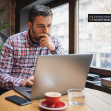 Small business owner comparing Google Business Profile, social media and business directory options on a computer